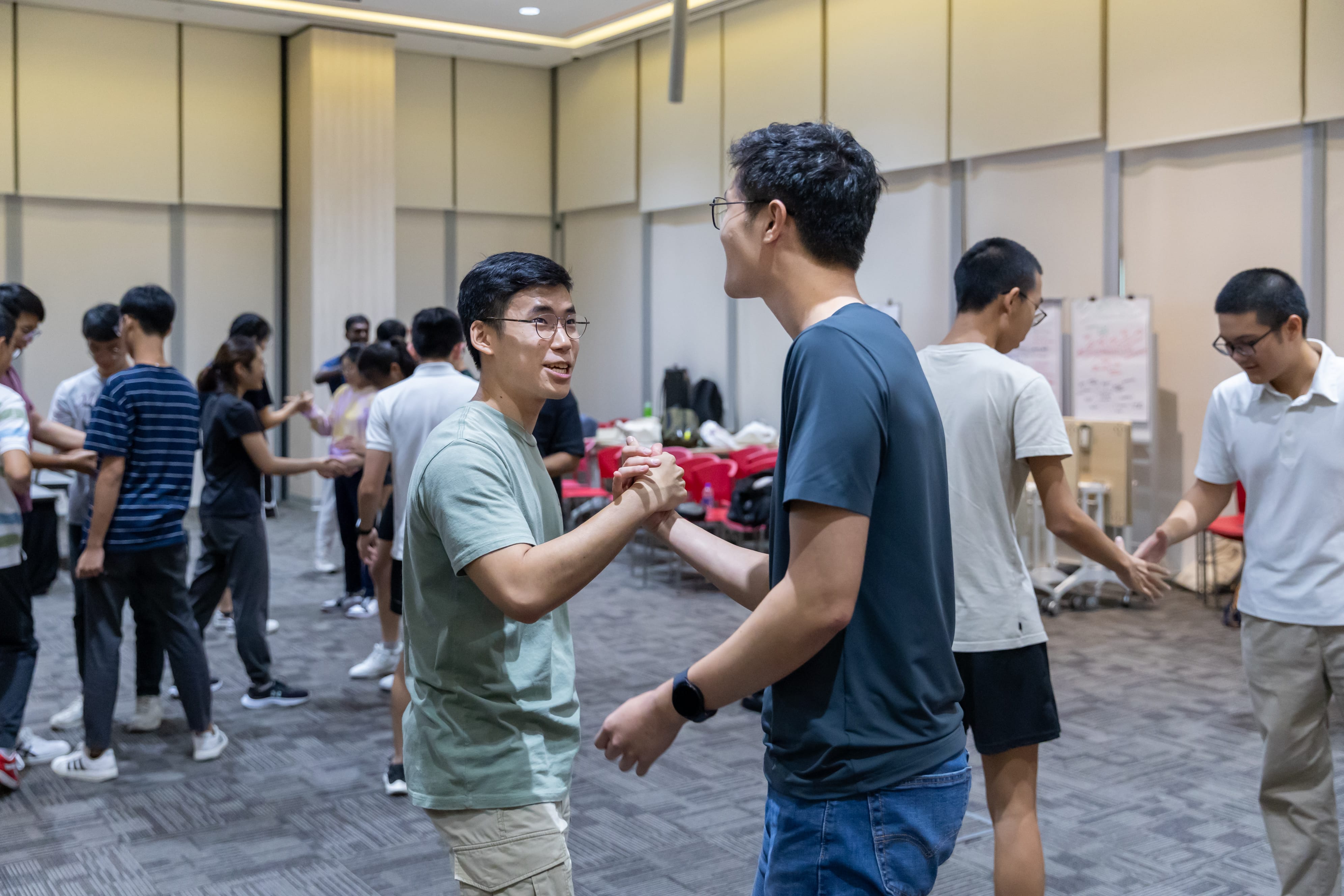 two scholars in a deep handshake